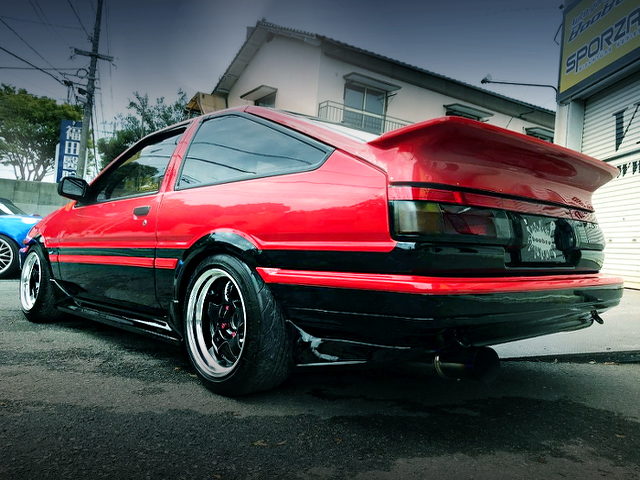 REAR EXTERIOR OF AE86 TRUENO GT APEX WITH RED AND BLACK TWO-TONE