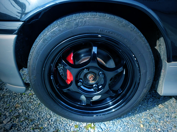 FRONT WHEEL AND RED BRAKE CALIPER