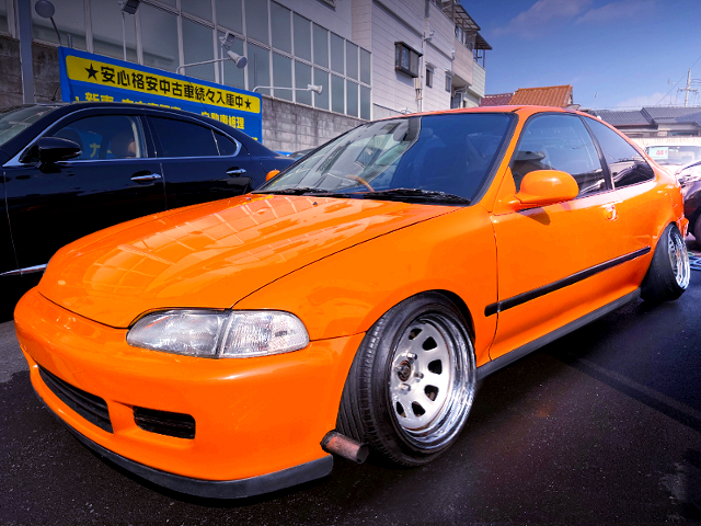 FRONT EXTERIOR of ORANGE EJ1 CIVIC COUPE.
