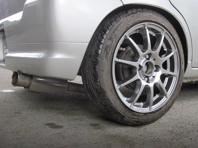 Aftermarket exhaust muffler and Rim.