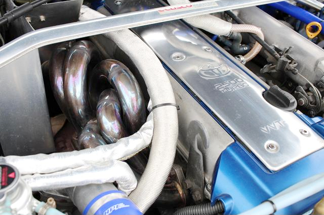 Aftermarket exhaust manifold on VVT-i 1JZ-GTE turbo engine.