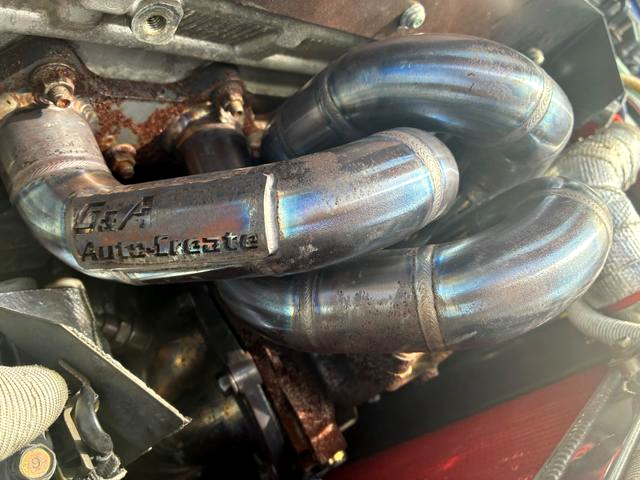 Aftermarket exhaust manifold on MIVEC 4G63 turbo engine.