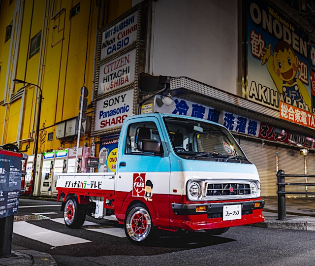 Front exterior of DA16T SUZUKI CARRY KC AC PS 3-WAY OPEN.