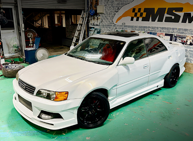 Front exterior of KAZAMA AUTO WIDEBODY GX100 TOYOTA CHASER.