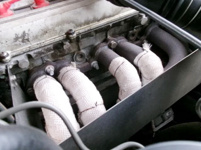 Aftermarket exhaust manifold on 1G-GE engine.
