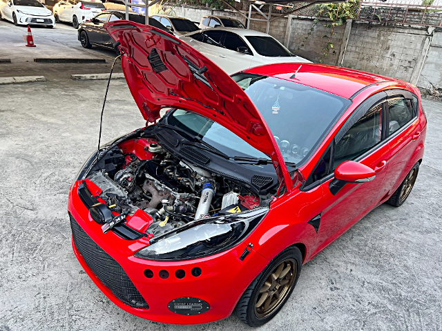 Hood open of 4th Gen Ford Fiesta.
