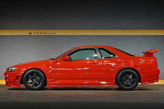 Left-Side exterior of Active red ER34 SKYLINE 2-DOOR 25GT TURBO.
