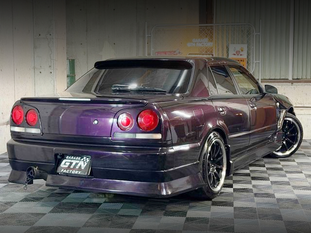 Rear exterior of GT-R faced R34 SKYLINE 4-DOOR GT.